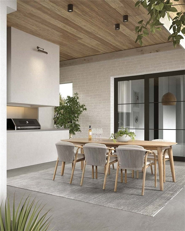 Boras teak armchairs around an outdoor dining table