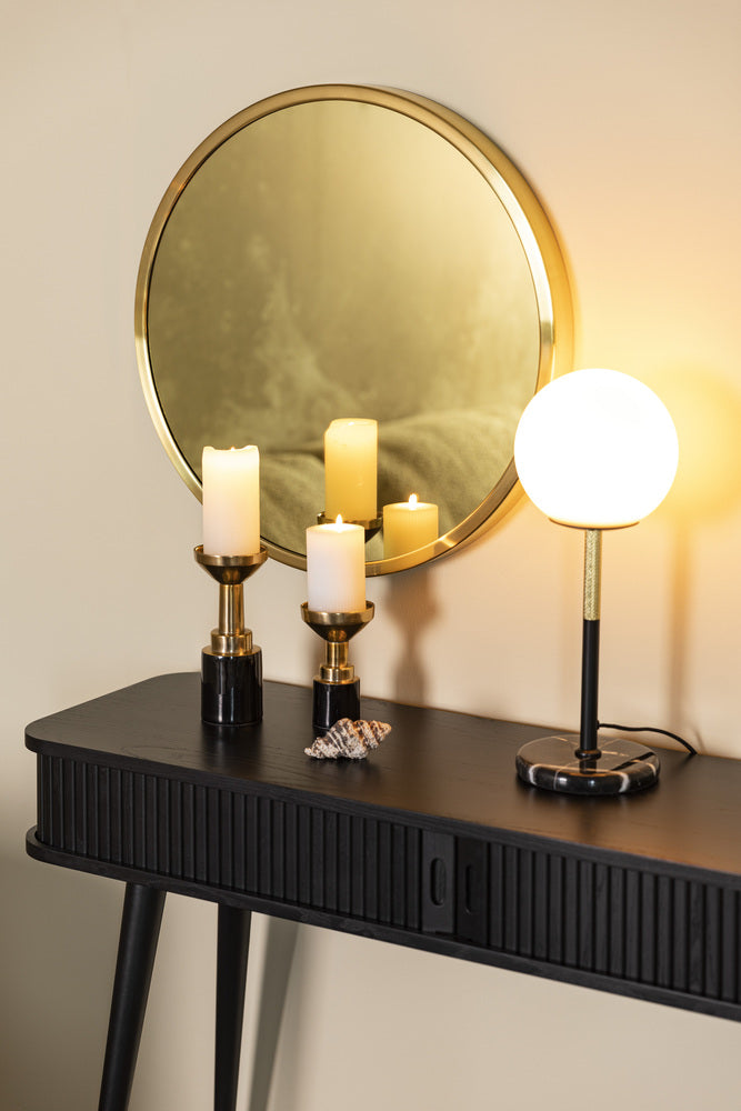 Glam candle holders on a console with a round mirror