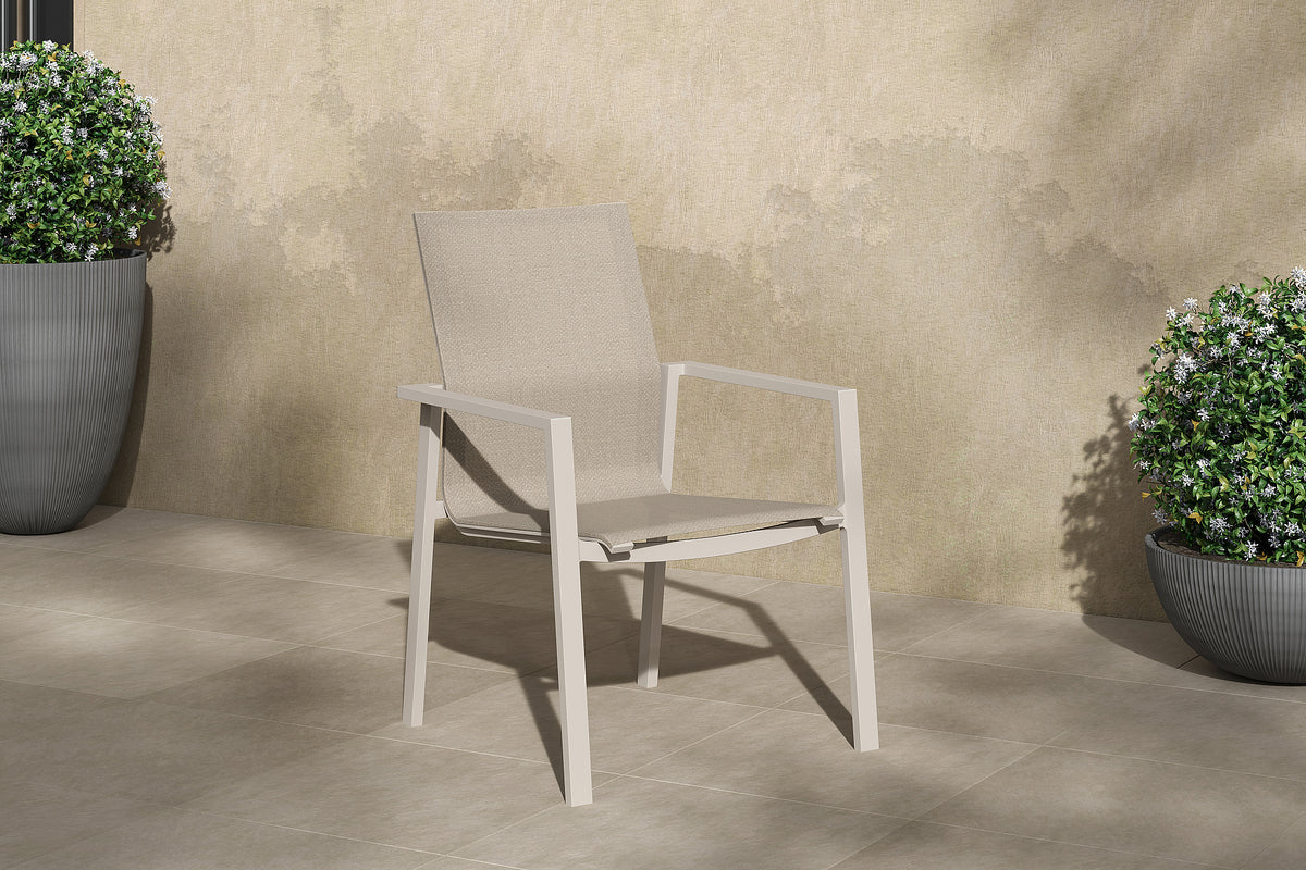 Beja Stackable Armchair Alu Dune Mat Batyline Serge Ferrari Eden Sand Domestica – Lifestyle – By a Wall with Plants