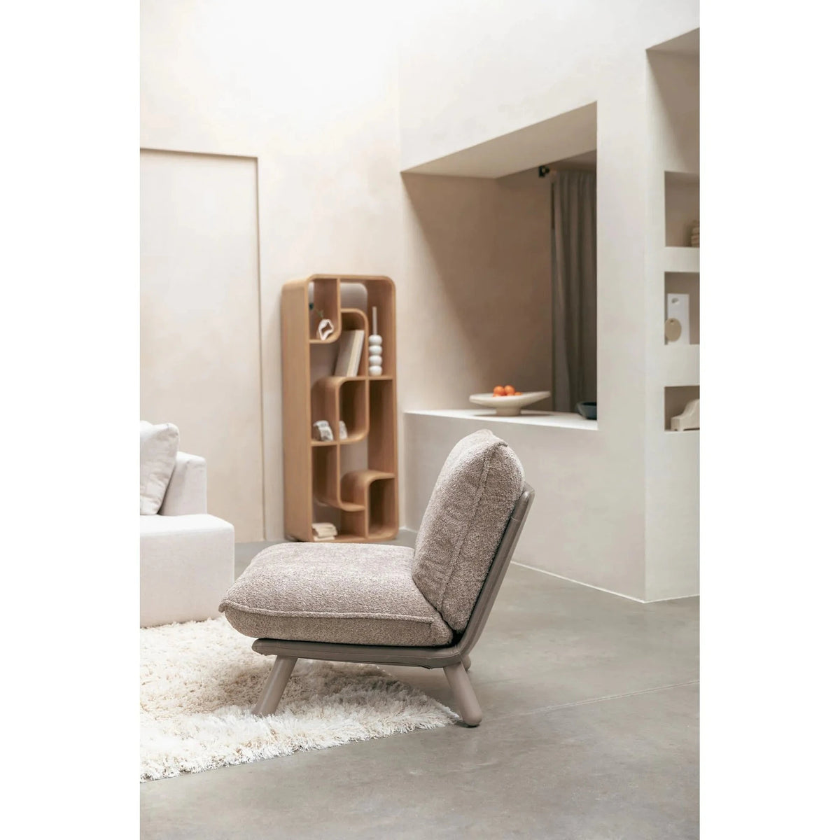 Lounge Chair Lazy Sack Soft Beige Domestica – Lifestyle – On a Rug Beside Shelving