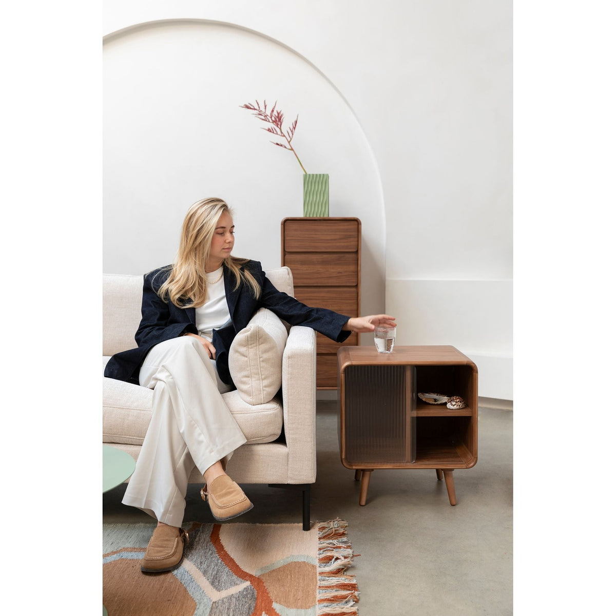 Side Table Rise Walnut Domestica – Lifestyle – Person Seated on a Sofa Beside the Side Table