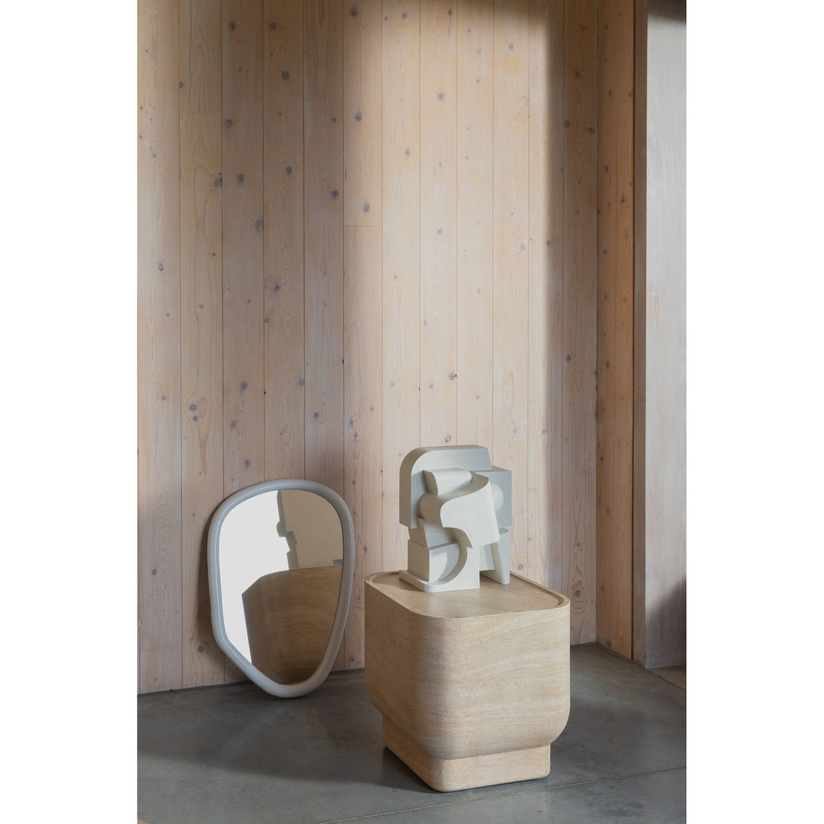 Side Table Noble Square Beige Domestica – Lifestyle – With Sculptures Against a Wood Wall