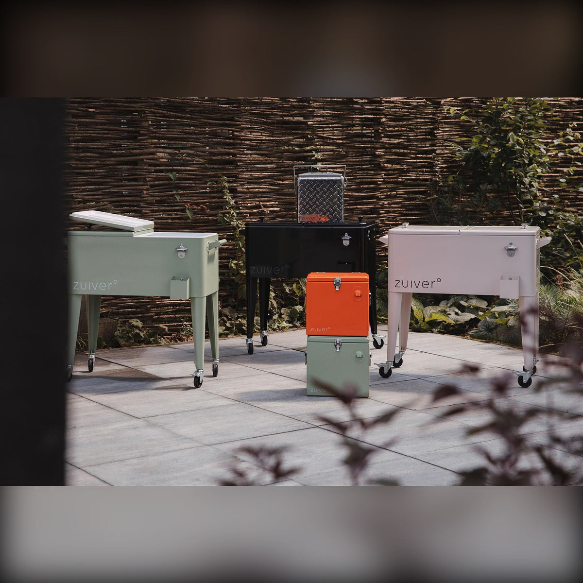 Cooler Be Cute Orange Domestica – Lifestyle – Garden Terrace with Green, Black and Cream Coolers