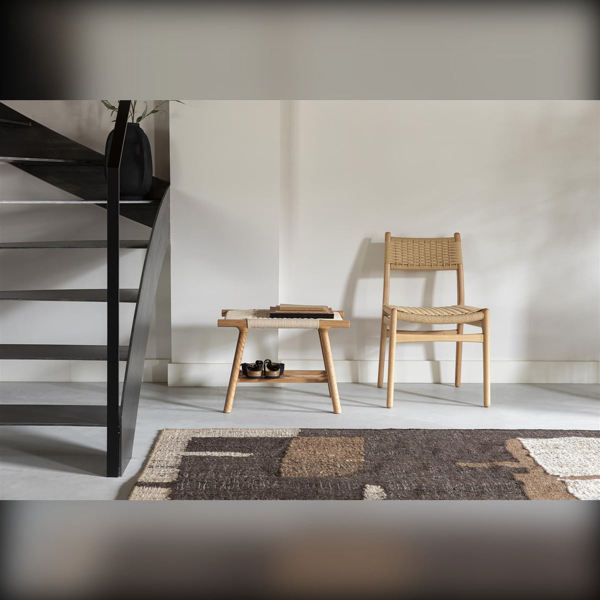 Dining Chair Cecile Natural Domestica – Lifestyle – Beside a Black Staircase with Stool