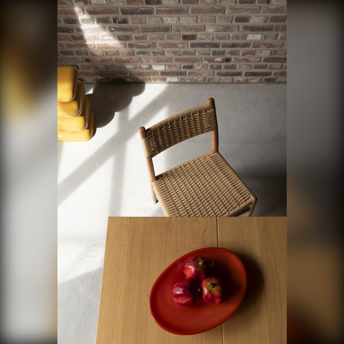 Dining Chair Cecile Natural Domestica – Lifestyle – At a Table with Red Bowl, Brick Wall