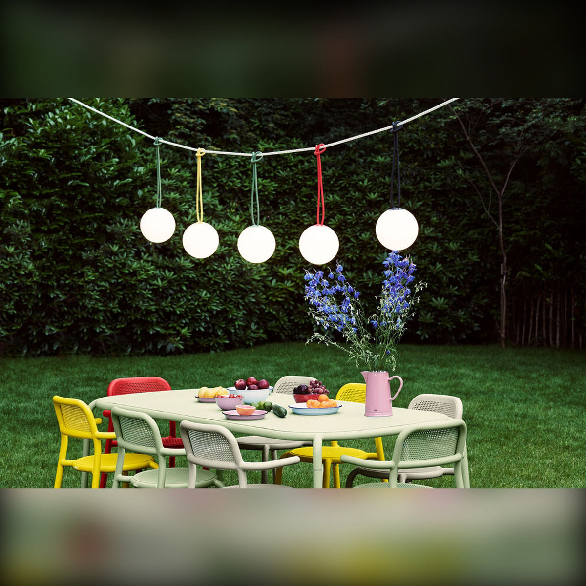 Bolleke Anthracite Domestica – Lifestyle – Row of Lamps over a Garden Dining Table