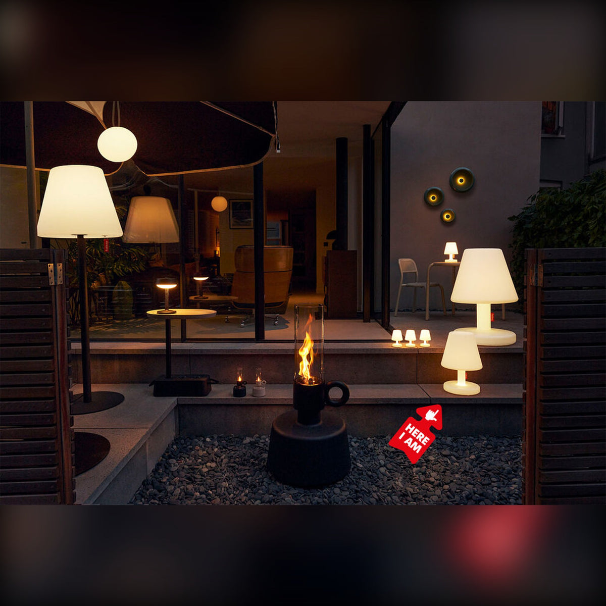 Edison the Medium White Domestica – Lifestyle – Lit Lamps in a Courtyard at Night