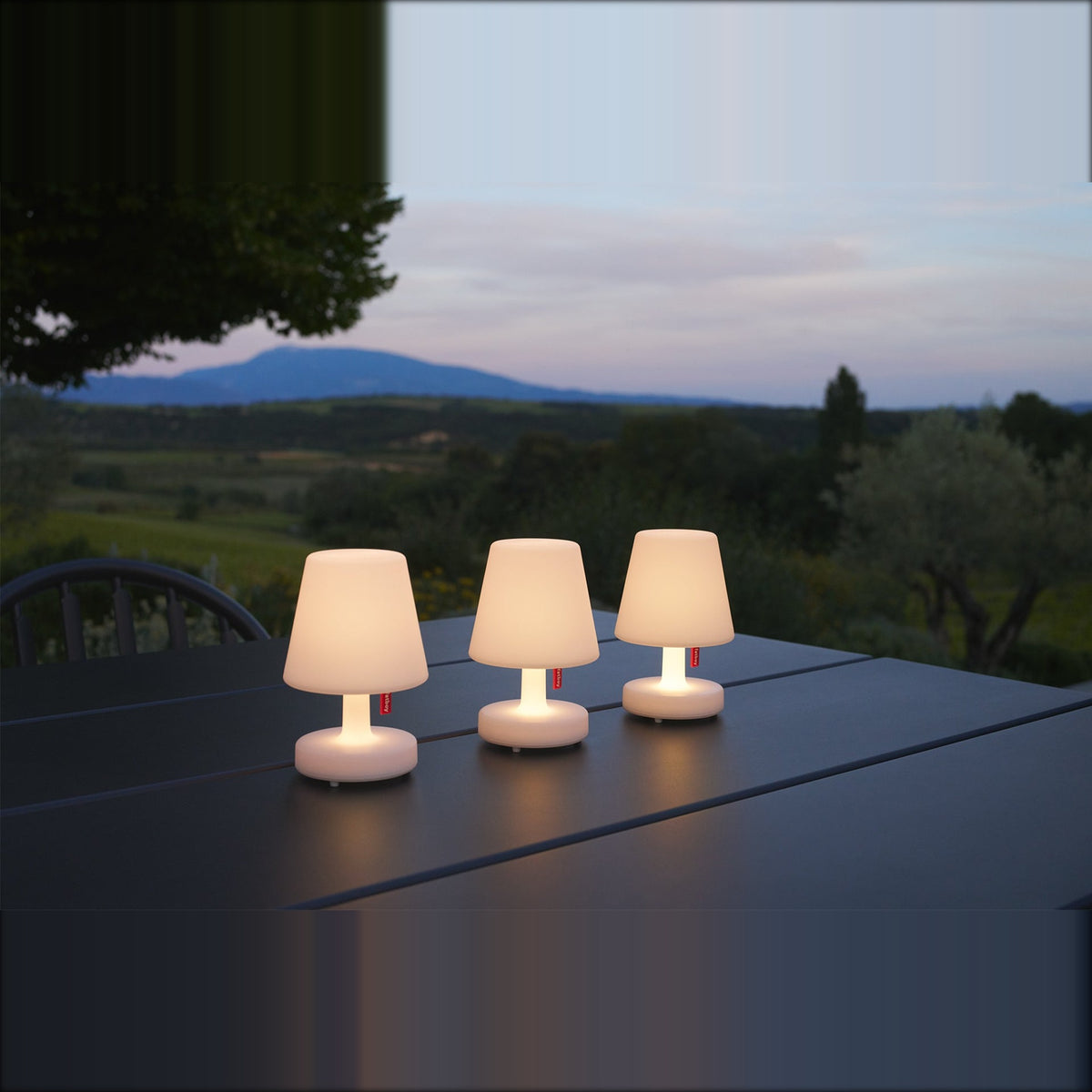 Edison the Mini Set 3 Pieces Domestica – Lifestyle – Lit on an Outdoor Table at Dusk