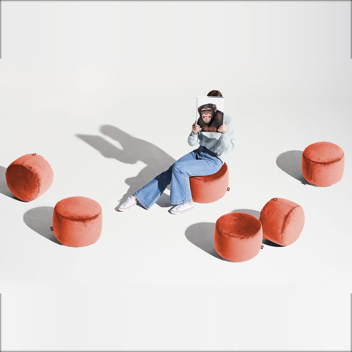 Point Velvet Recycled Rhubarb Domestica – Lifestyle – Person Seated Among Five Poufs