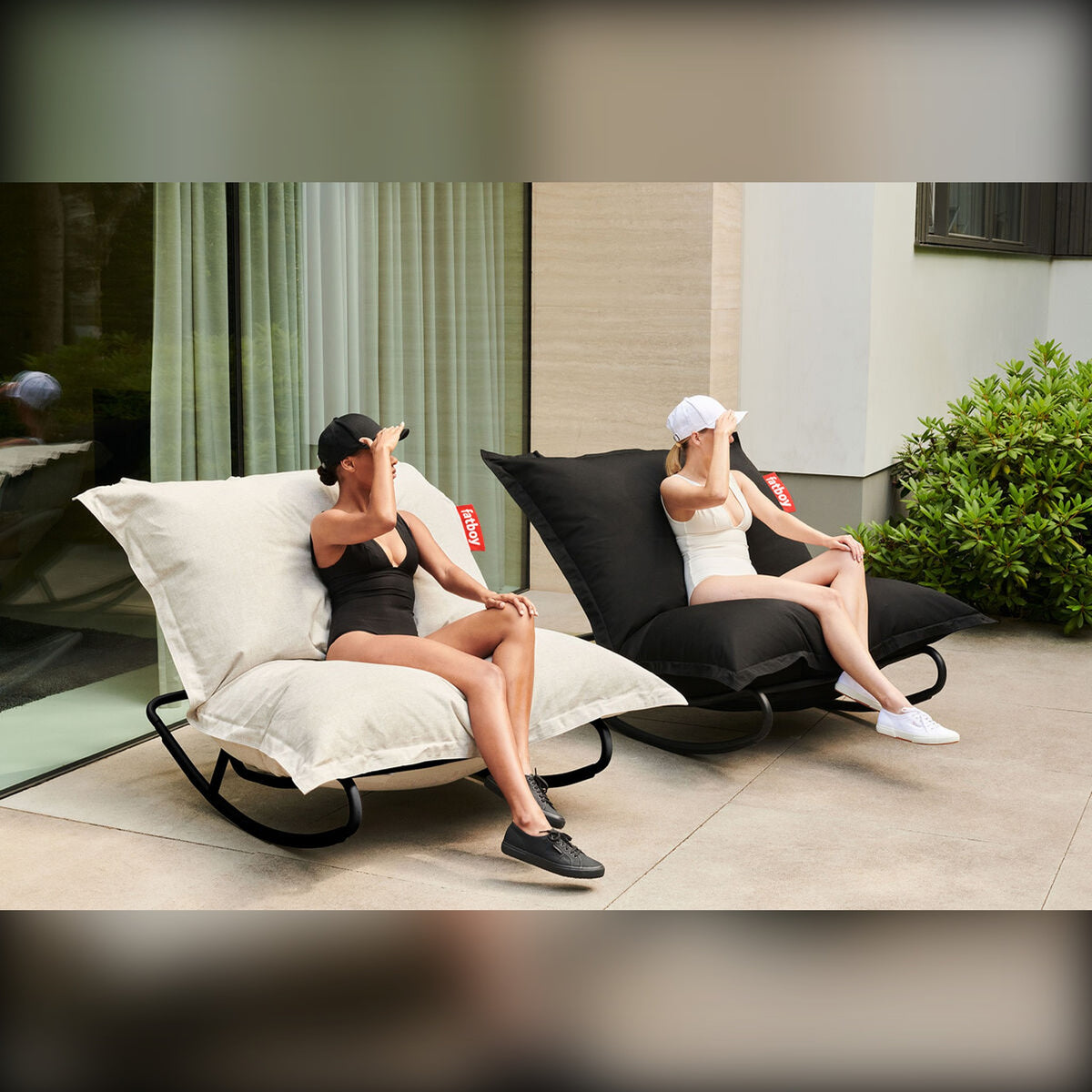 Rock 'n Roll Black Domestica – Lifestyle – Two People Relaxing on Rocking Loungers on a Patio