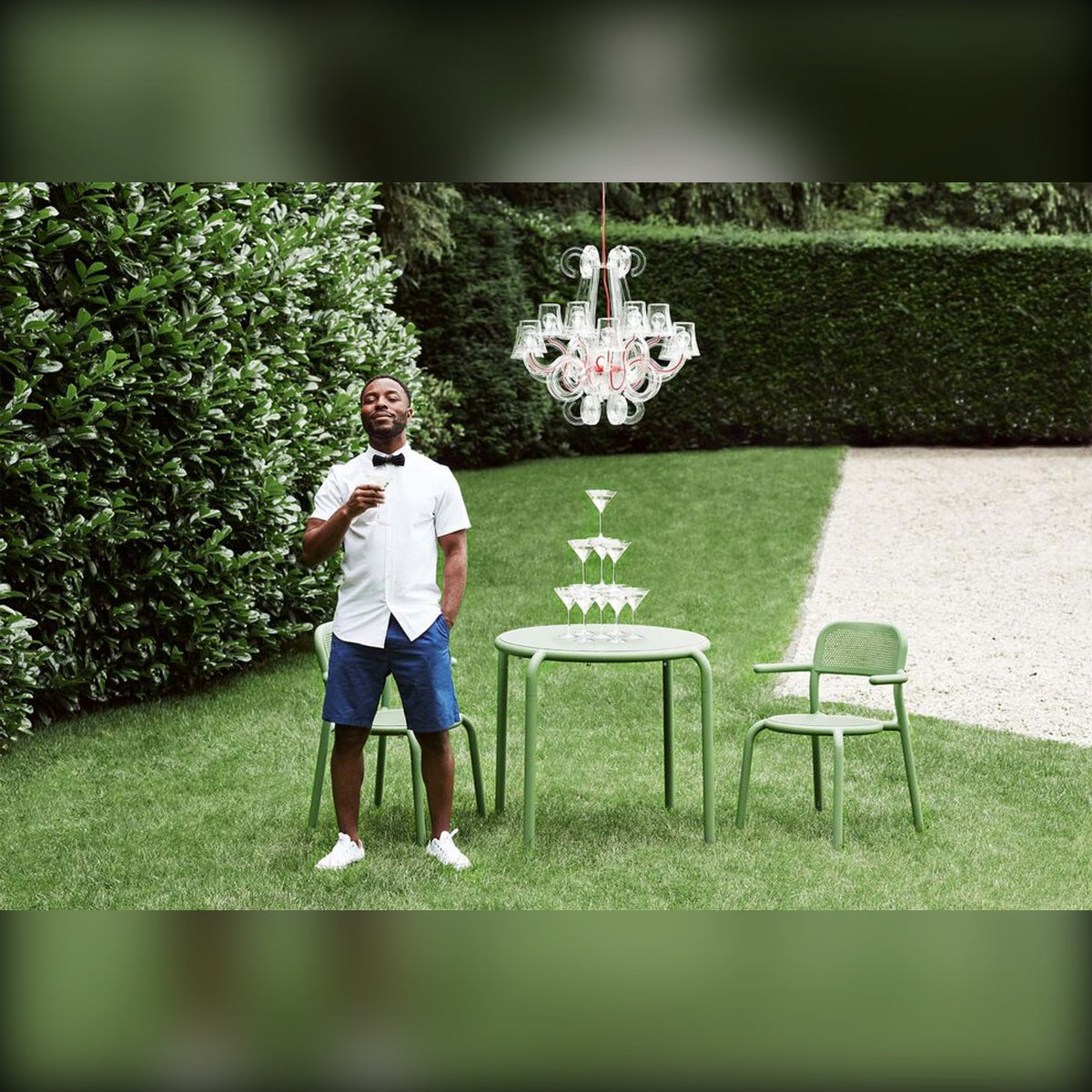 Rockcoco Transparent Domestica – Lifestyle – Person on a Lawn Beneath the Chandelier