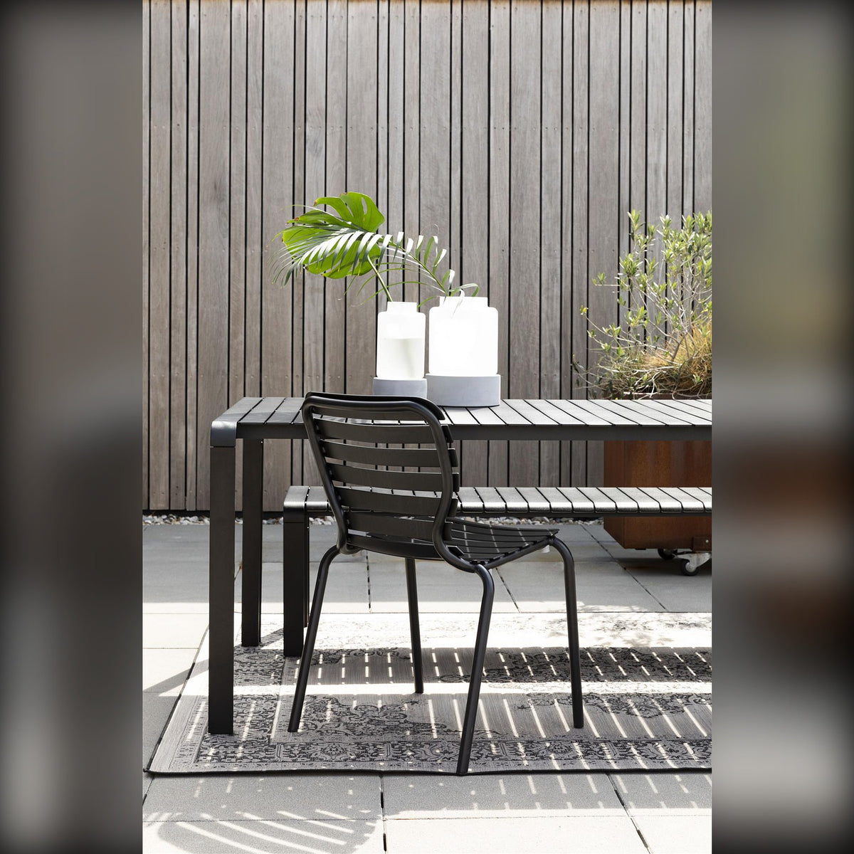 Garden Chair Vondel Black Domestica – Lifestyle – At a Black Outdoor Table, Portrait