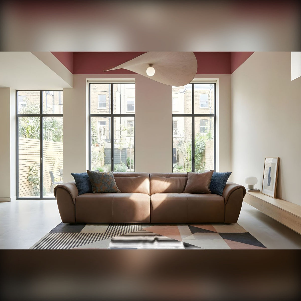 Noks Domestica – Lifestyle – Brown Sofa by Tall Windows