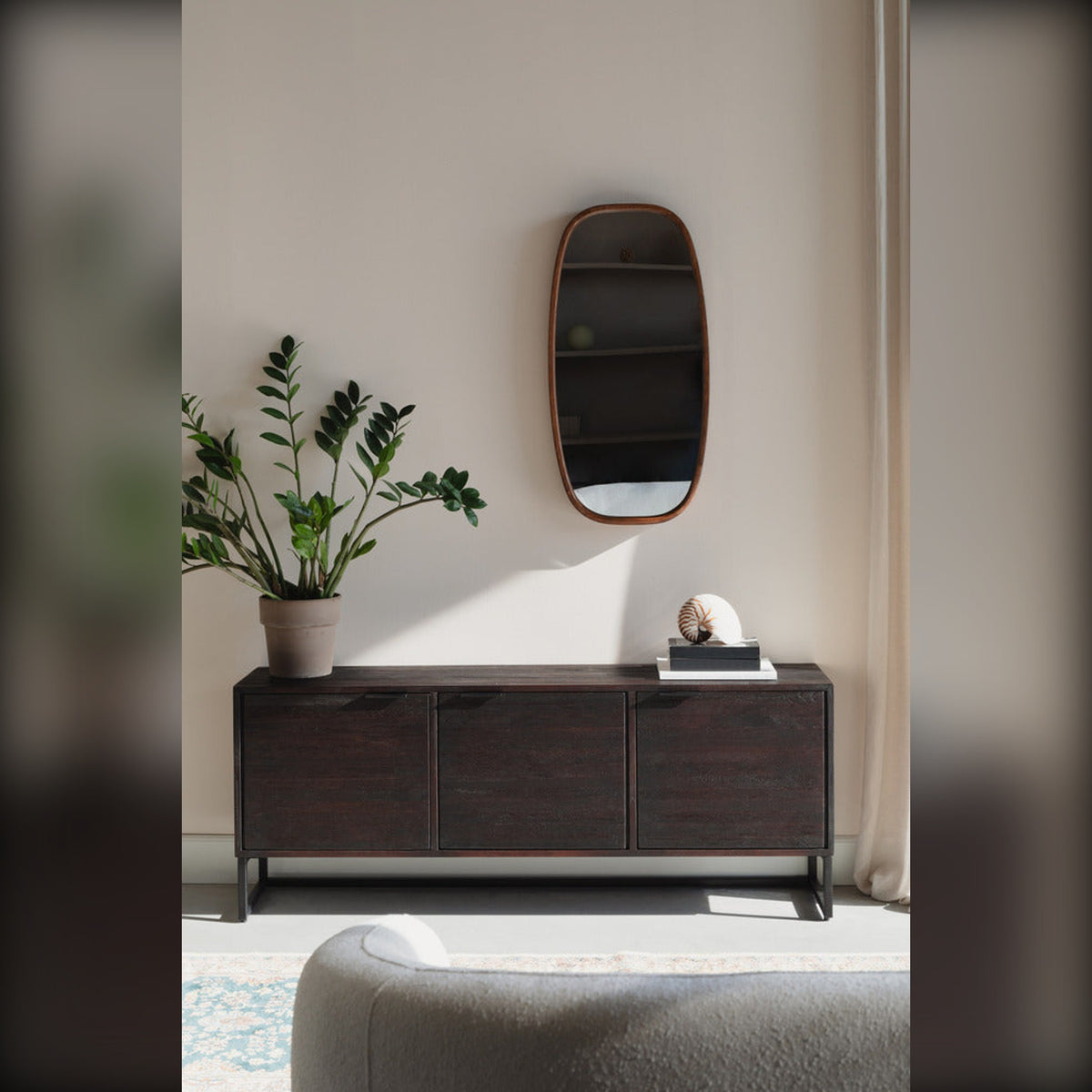 Sideboard Webster 3 Doors Dark Brown Domestica – Lifestyle – Below a Wall Mirror with Plant
