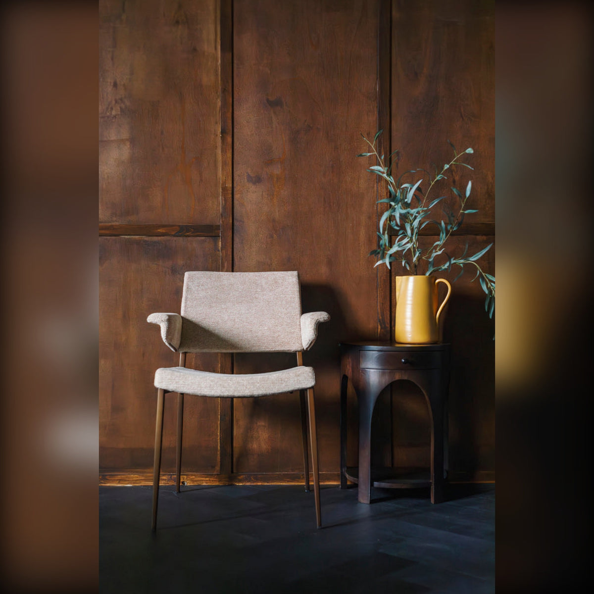 Side Table Belvedere Walnut Domestica – Lifestyle – Beside a Chair Against a Wood-Panelled Wall