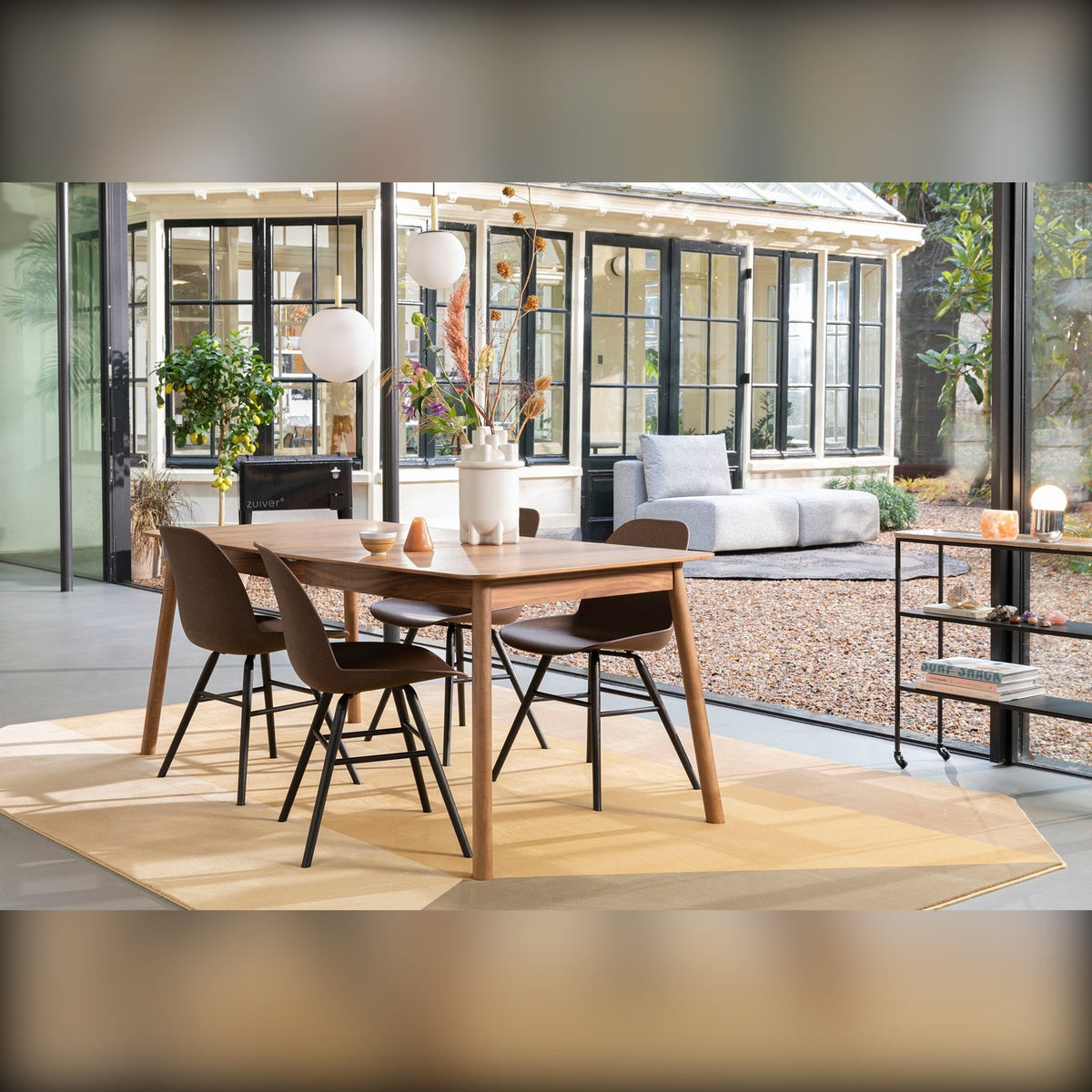 Dining Table Glimps 180/240x90 Walnut Domestica – Lifestyle – Glass Conservatory with Dark Dining Chairs
